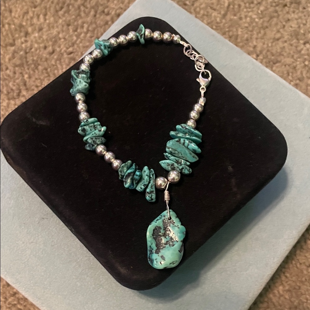 turquoise nugget and sterling silver bracelet with a lobster claw clasp.